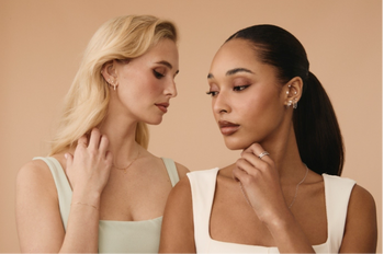 Two women wearing Tish Lyon earrings in an ear stack style